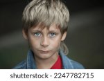 Portrait of a 10 year old boy with blond hair and blue eyes