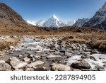 Small photo of Three passes trek at its best. Descending from Cho-la pass in direction of Dzongla, crossing little river, with constant view of Ama Dablam in the background