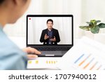 Young asian chinese leader or businessman on management forum, teleconference, town hall or press video conference online with work remotely at home during coronavirus and business continuity concept.