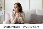 Small photo of Unhappy Female employee latin mom think sit sofa couch at home living room need help support panic coronavirus financial debt crisis in life insurance feel pain distress pensive regret lost upset.