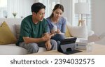 Small photo of Young married asia people prepare pregnant plan checkup preconception consult at home sofa. Clinic app illness screen on online advice doctor remote exam telemedicine video call talk on tablet phone.