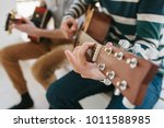 Learning to play the guitar. Music education and extracurricular lessons. Hobbies and enthusiasm for playing guitar and singing songs.