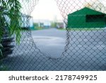 Small photo of Hole in the fence. Mesh wire boundary. Steel mesh barrier fence. Chain link fence with Hole.