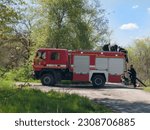 Small photo of zaporozhye, ukraine, may 17, 2023,fire engine, firefighters, fetching water, Ministry of Emergency Situations, rescuers, Zaporozhye, red fire truck fetching water from the river, fire extinguishing