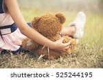 Teddy Bear picnic happy child girl kid holding fluffy toy with little hand sitting on grass field. cute girl love teddy bear best friends hug holding together. Kids on playground Picnic Best Friend