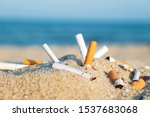 Cigarette Butts In Yellow Sand...