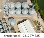 Small photo of Drone view of large agricultural grain silos in East Anglia, UK. A lorry can be seen being loaded with dried grain from a silo.