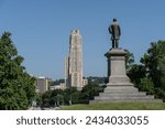 Small photo of Pittsburgh, Pennsylvania – July 23,2023: A statue of Edward Bigelow outside Phipps Conservatory overlooks Shenley Avenue and the Cathedral of Learning, Pittsburgh University.