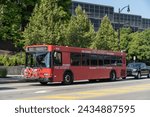 Small photo of Pittsburgh, Pennsylvania – July 23,2023: A Port Autority red city bus with bicycle on Forbes Ave. in Pittsburgh, Pa.