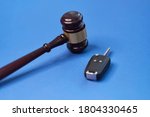 Small photo of Driver license revocation concept next to the judge hammer. Traffic violation concept by car next to judge hammer. Revocable trust on a wooden desk.