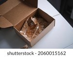 Small photo of delivery box from a store and discovers a broken glass. An improperly packed item crashed on delivery