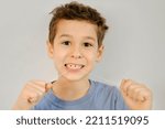 Small photo of Cute little boy flossing his teeth. soft thread of floss silk or similar material used to clean between the teeth