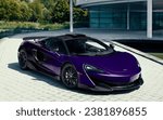 Small photo of Como, Italy - October 28, 2023: New purple McLaren P1 parked in the driveway in front of a business. Which of the two will cost more?