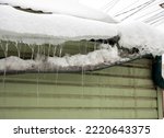 Gutter broken by snow masses sliding from the roof