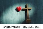 Small photo of Red heart with wood crucifix on grey marble. Concept Jesus loves you, Jesus crucify himself on cross with love. Forgiving sin , God's love, Easter time , Faith God. Christianity background.