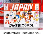 Small photo of tokyo, japan - september 21 2021: Cardboard on a stall of an Olympics Store depicting Japanese manga or anime characters Astro Boy, Sailor Moon, Luffy, Naruto, Son Goku, with slogan Go for it Japan.