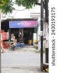 Small photo of Malang, Indonesia - January 25 2024: A simple small shop on the side of the road in Indonesia that sells basic necessities, snacks and household necessities