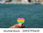 Small photo of Heart shape erasure holding at beach view background. Cozumel, Mexico.