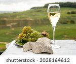 Small photo of White chalk stones from Cote des Blancs near Epernay, region Champagne, France, glass of blanc de blancs champagne from grand cru vineyards in Cramant and white chardonnay grapes close up