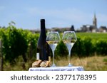 Small photo of Glasses of white wine from vineyards of Pouilly-Fume appelation and example of flint pebbles soil, near Pouilly-sur-Loire, Burgundy, France.