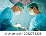 Small photo of Emergency surgery. Surgeons during surgical intervention in clinic