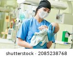 Newborn baby in hospital at neonatal resuscitation center with nurse