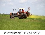 Agricultural machinery in rice plantation.
