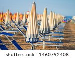 Beach in Rimini, Italy. Umbrellas on sandy beach in resort city Rimini on sunny morning. Summer vacation to sea rest in Rimini