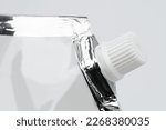 Small photo of Blank spout pouch with cap or doy pack. Front view of blank glossy white doypack with cap or stand-up pouch isolated on white background.