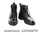 Pair of black leather boots, dress boots for men. Black brogue boots on a white background. Man's legs in black jeans and brown leather boots.