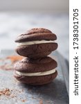 Small photo of Chocolate whoopie pies on gray stone background