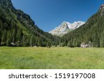 Small photo of Pristine Mountain Landscape in Swiss Alps inviting to stroll and tag along for a leisure day hike of fly fishing amidst the stunning mountain peaks soaring into the blue sky.Concept: Pristine, holiday