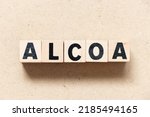 Small photo of Alphabet letter block in word ALCOA (Abbreviation of Attributable, Legible, Contemporaneous, Original and Accurate) on wood background