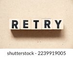 Small photo of Alphabet letter block in word retry on wood background