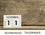 White block calendar present date 11 and month November on wood background
