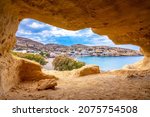 Small photo of Matala beach with caves on the rocks that were used as a roman cemetery and at the decade of 70's were living hippies from all over the world, Crete, Greece