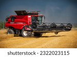 Small photo of Stepanov, Czechia, 6.26.2022, A modern red combine harvesting barley during the summer in the Czech Republic, in Central Moravia, before a storm. Combine harvester working in the field using GPS