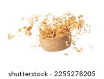 Small photo of Instant Noodle fly in wooden bowl, yellow instant noodle float explode, abstract cloud fly. Curved dried instant noodles splash throwing in Air. White background Isolated high speed shutter