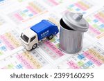 Small photo of Garbage truck and calendar. Translation: cleaning business, garbage separation, Monday, Tuesday, Wednesday, Thursday, Friday, Saturday, Sunday, flammable, non-flammable, bottle, can, plastic