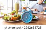 Small photo of Blue alarm clock with IF (Intermittent Fasting) 16 and 8 diet rule and weight loss concept.-Diet plan concept