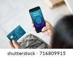 Secure payment with touch id scan concept.Woman hands using mobile phone and holding credit card