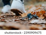 Man lost keys, selective focus on object and leaving man's legs in out of focus.