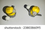 Small photo of Surabaya, East Java Indonesia on October 20, 2023. Two minion toys play ball. Yellow minion toy fast food gift.