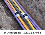 Small photo of connecting underground electric cable infrastructure installation. Construction site with A lot of communication Cables protected in tubes. high speed Internet Network cables are buried