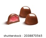 Two delicious chocolate bonbons with half showing starwberry filling, isolated