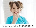 The kid lost a tooth. Baby without a tooth. Portrait of a little girl no tooth. High quality photo
