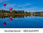 Hot air balloon festival in Pagosa Springs Colorado an amazing getaway on a mirror still lake reflecting colorful balloons all over the morning sky