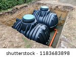 Two plastic underground storage tanks placed below ground for harvesting rainwater. The underground water septic tanks, for use as ecological recycling rainwater.