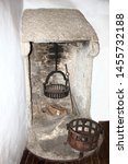 Small photo of 13th Century fireplace with cooking pot and andiron.