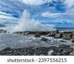 Small photo of Amazing photos of ocean waves crashing against the breakwater. A rocky beach sheltered by a breakwater.